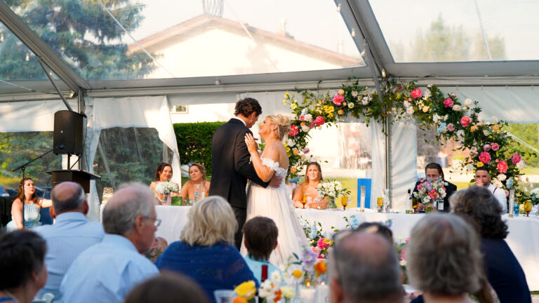 Bride and groom kissing at wedding reception.