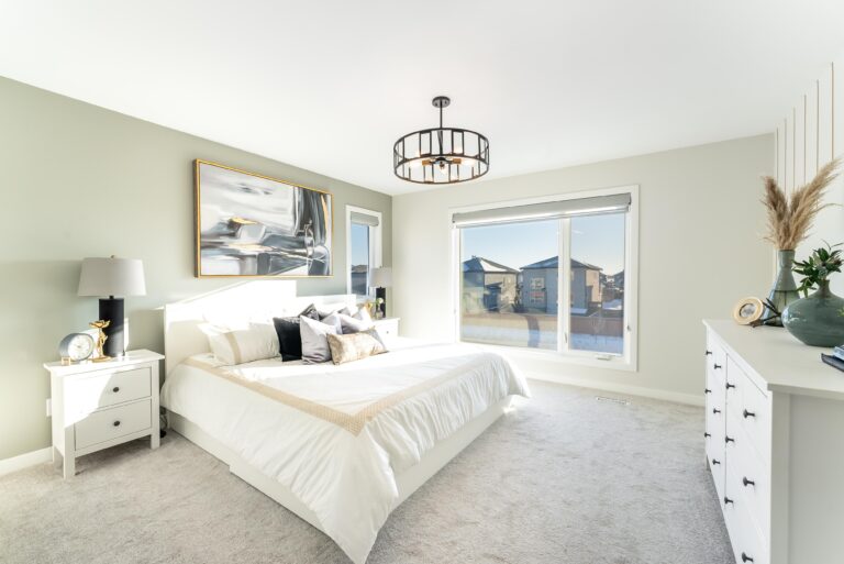 Bedroom at 7 Creemans Crescent with white bed, large window, dresser, and bright natural light