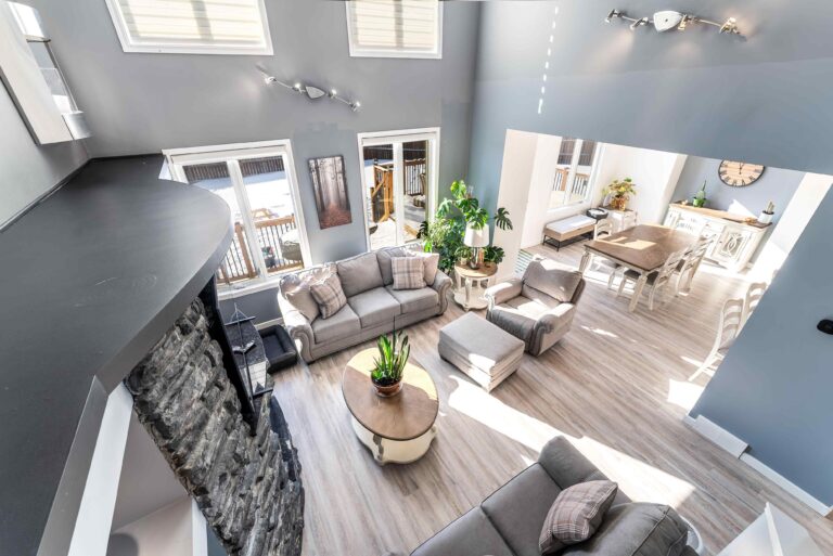 Bright open-concept living room with vaulted ceiling in a Winnipeg home