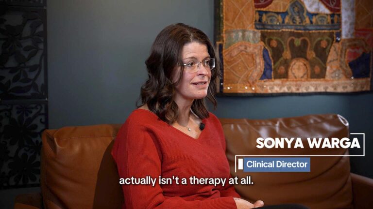 Woman speaking in a professional interview video with lower-third title graphics for business content marketing