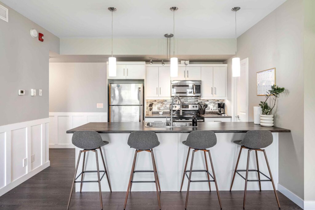 Modern kitchen with island seating and pendant lights for a Winnipeg real estate listing