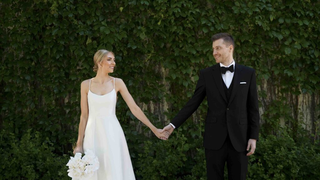 Couple holding hands on wedding