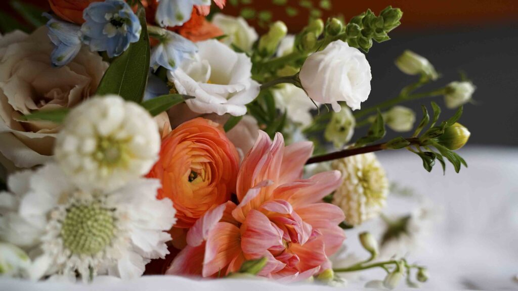 Soft wedding floral bouquet with peach, white, and blue flowers for a Manitoba wedding