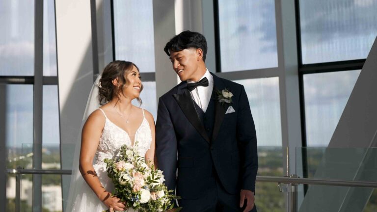 Bride and groom smiling together during an indoor wedding portrait session