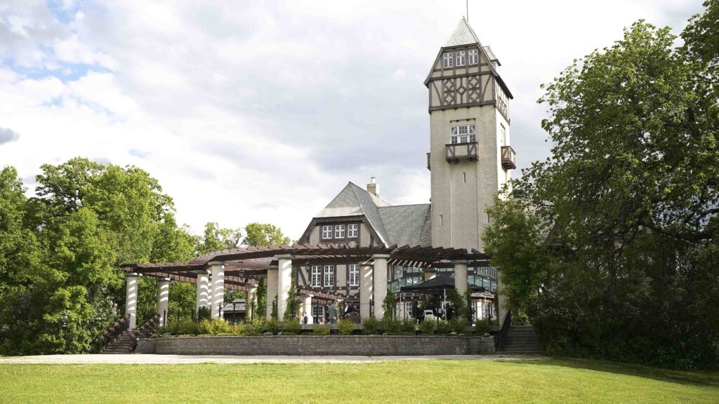 Historic Manitoba wedding venue exterior with tower, garden, and outdoor grounds
