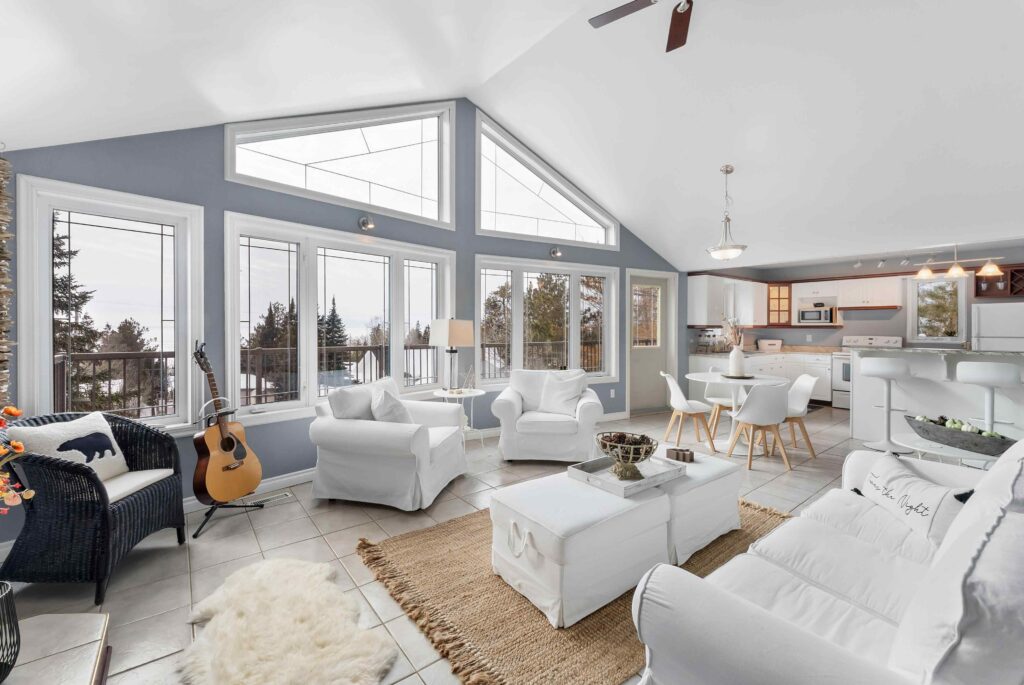 Bright open concept living room and kitchen with large windows for real estate listing