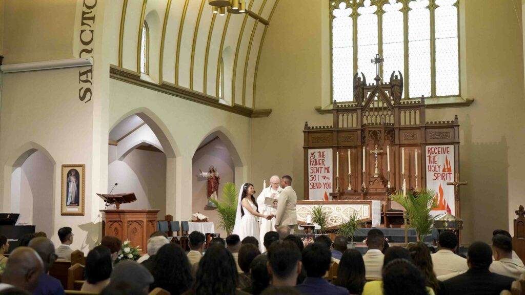 Church wedding ceremony with couple exchanging vows at the altar in front of guests