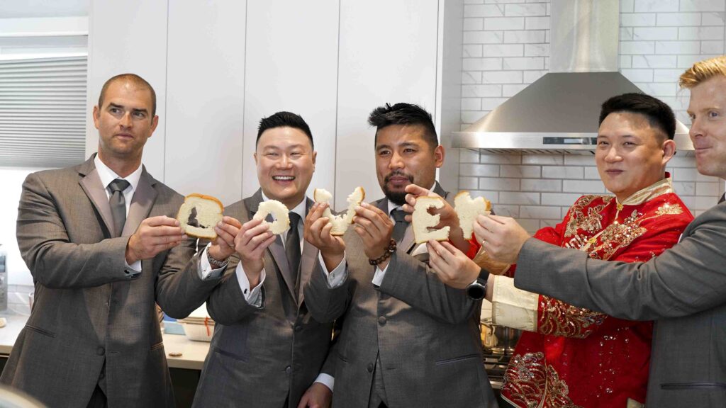 Groom and groomsmen sharing a fun wedding morning moment before the ceremony