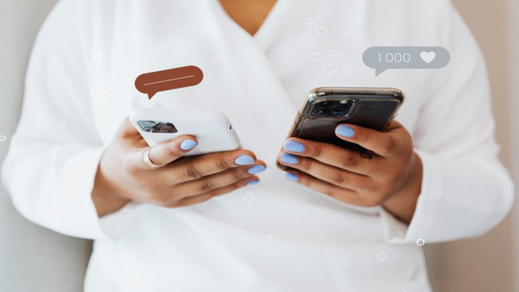 Person using two smartphones with social media likes and message icons