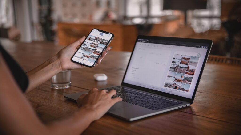 Person planning social media content on a laptop and smartphone